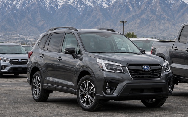 Pre-owned Subaru SUV at a mountain dealership lot